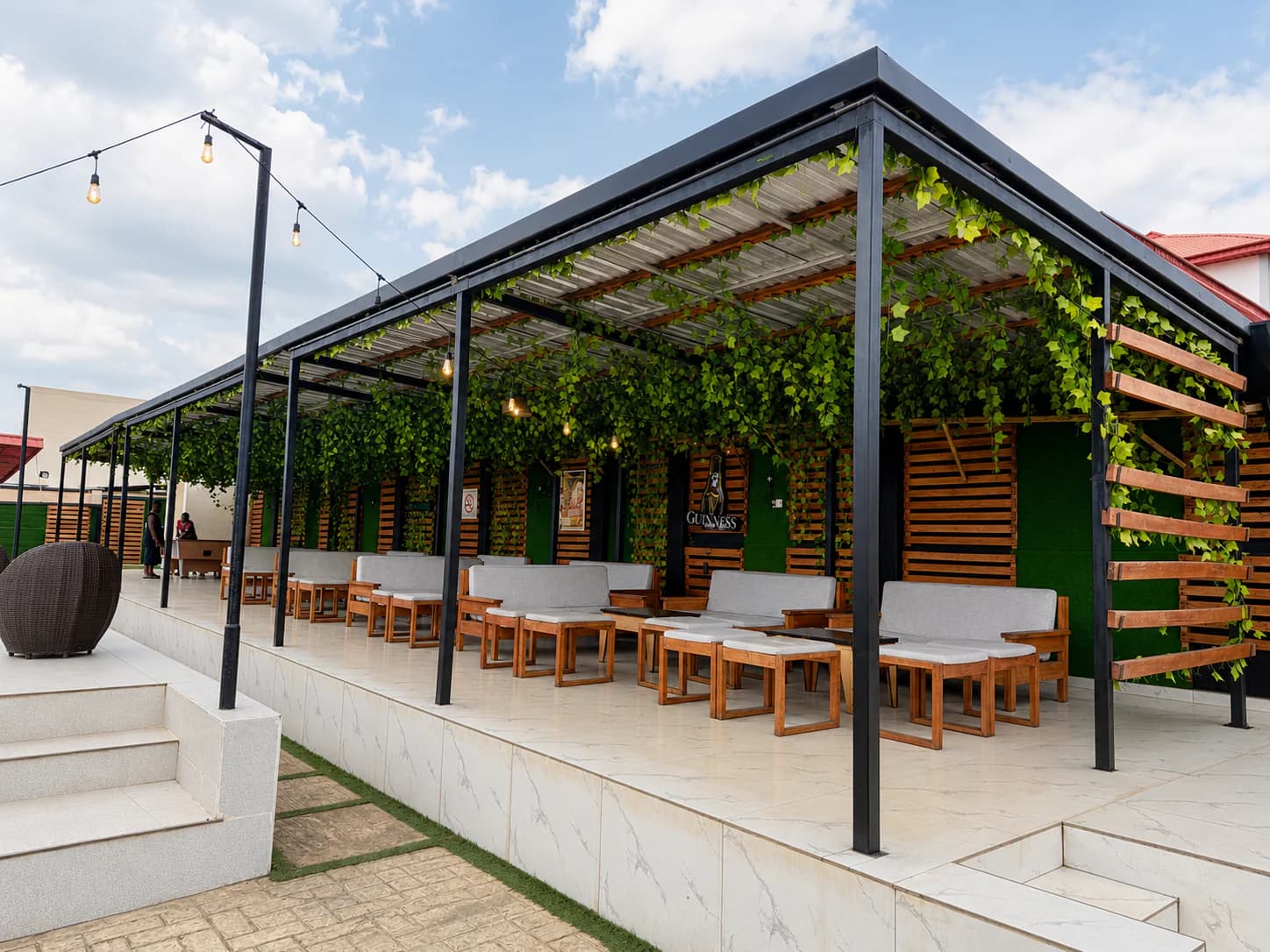 Covered outdoor guest lounge beside the Ellysam pool